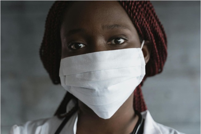 Black woman clinician in mask