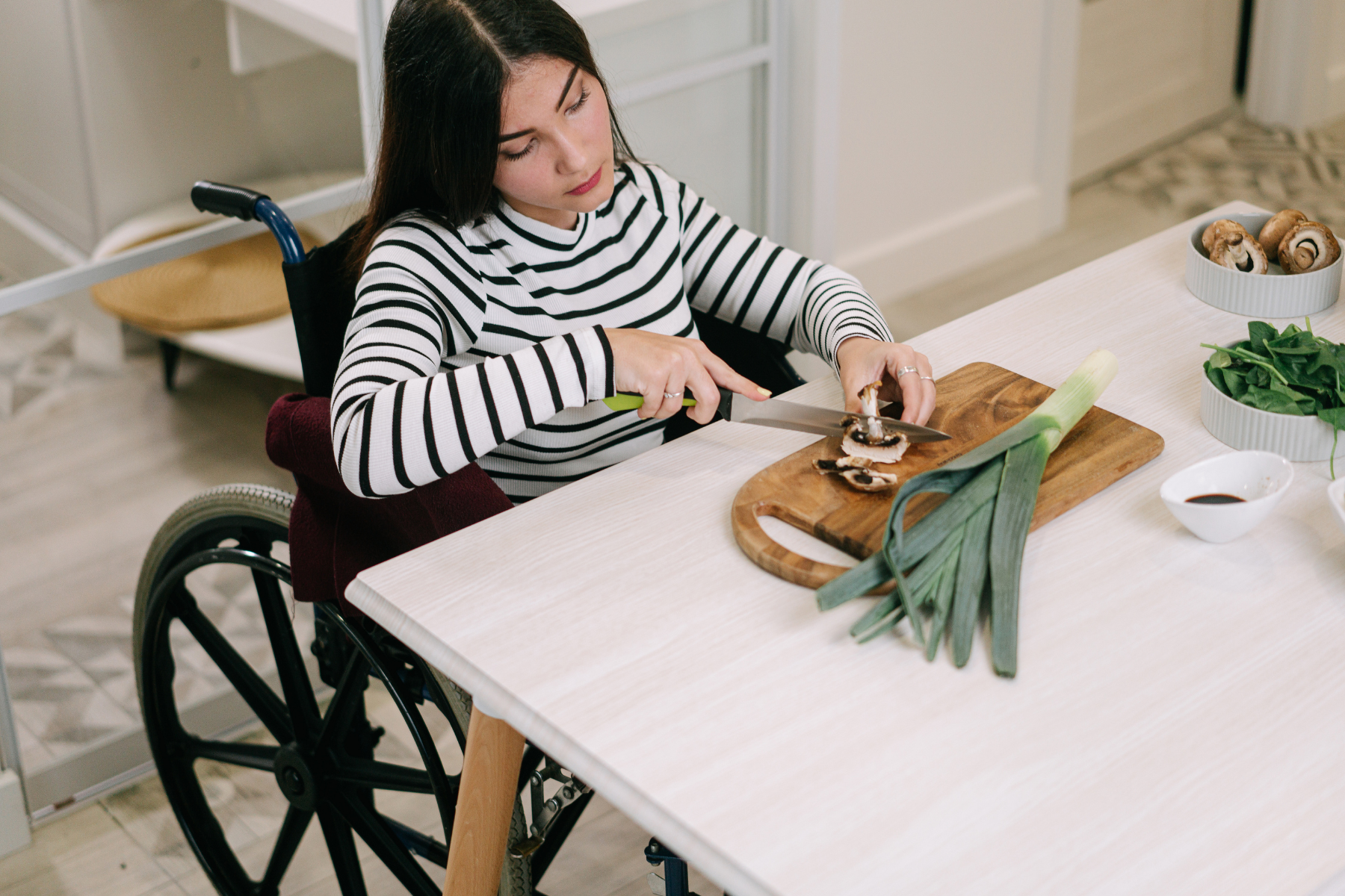 Woman in wheelchair cooking